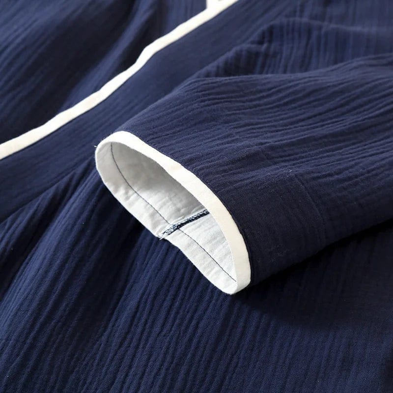 Le Monde du Peignoir navy blue cotton kimono with white trim and textured fabric.