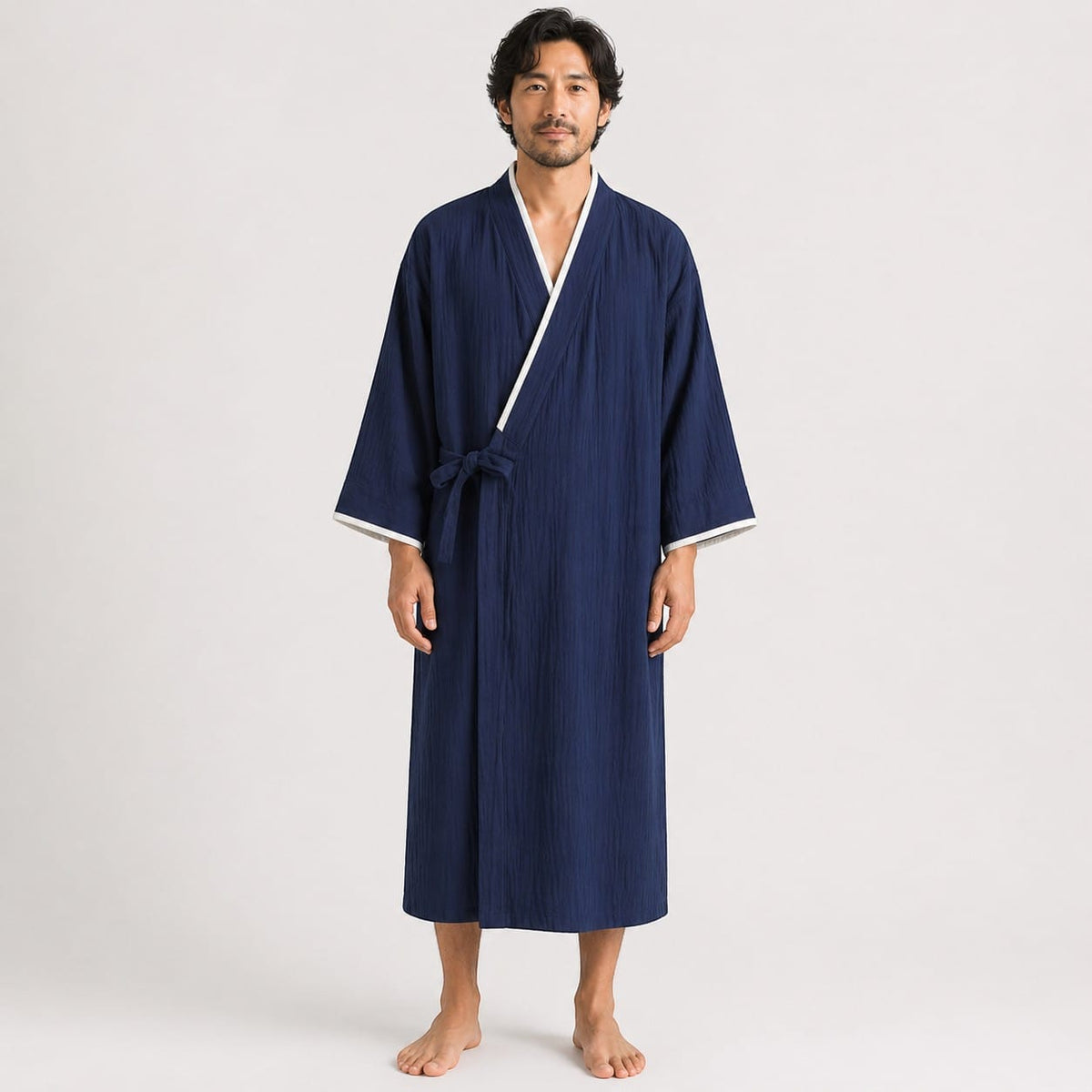 Le Monde du Peignoir navy blue lightweight cotton kimono robe with white trim and tie closure, worn by a man.